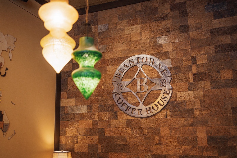 Metal BeanTowne Coffee House 1993 sign on a cork wall