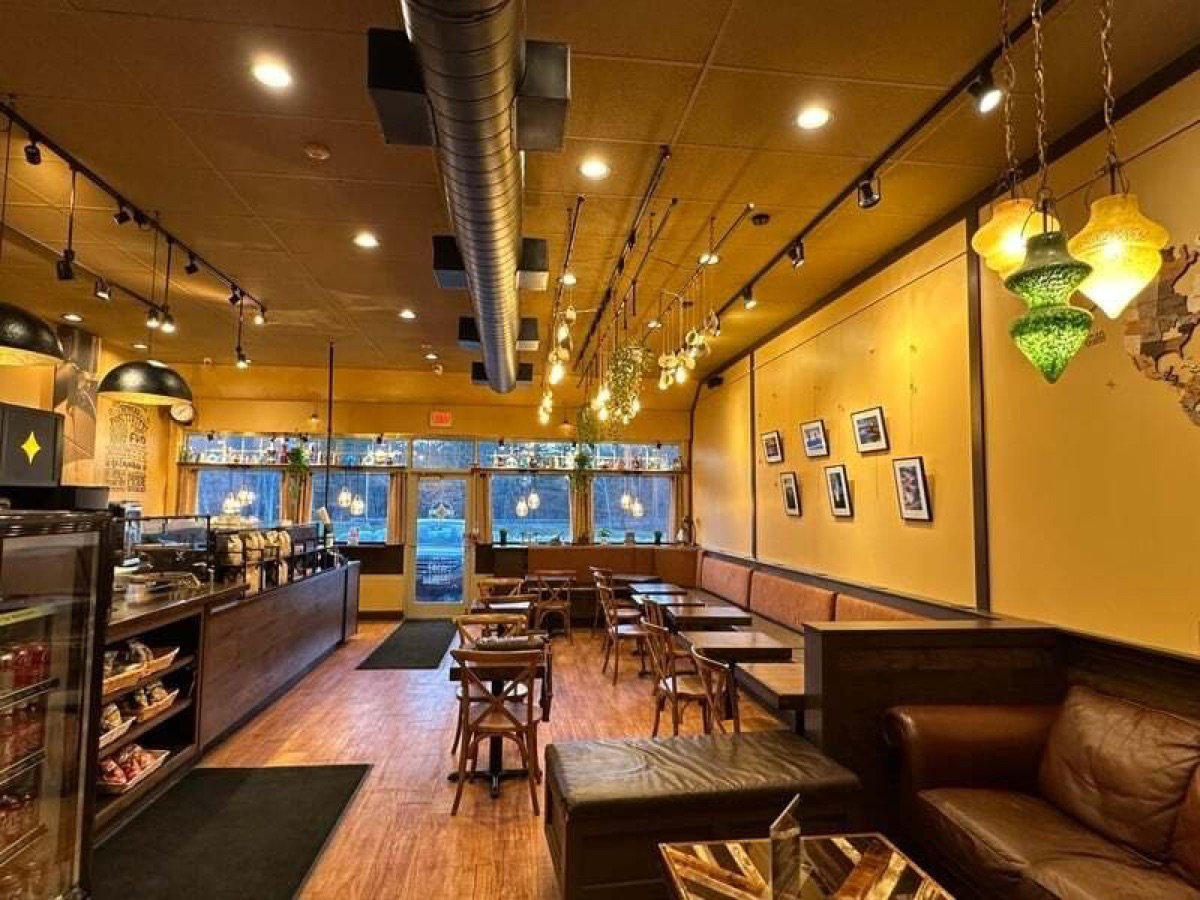 Warm café interior with leather couches and hanging lanterns