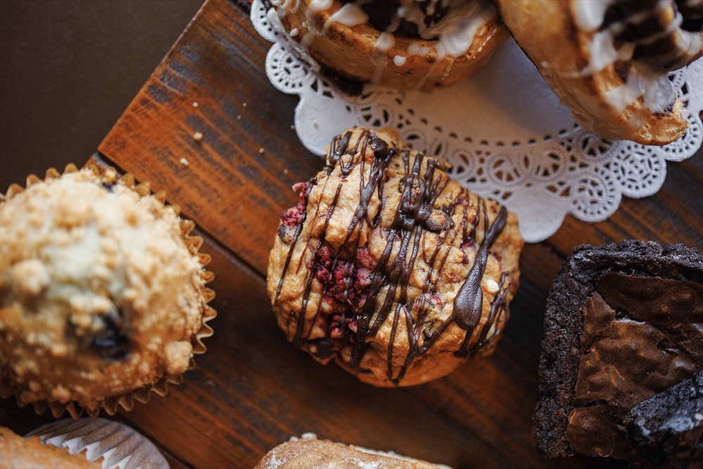 Fresh-baked muffins, brownies, and cinnamon rolls on a wooden board