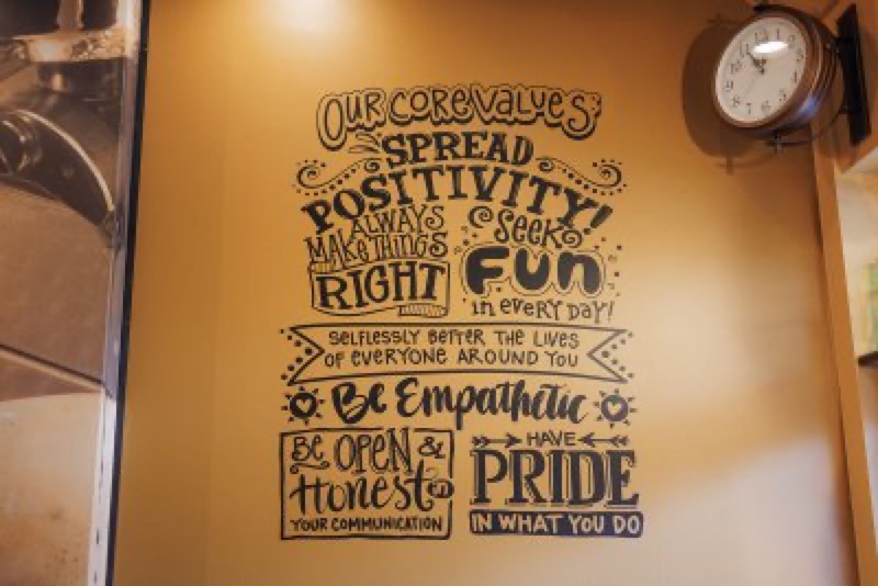 Hand-lettered core values mural: spread positivity, seek fun, be empathetic